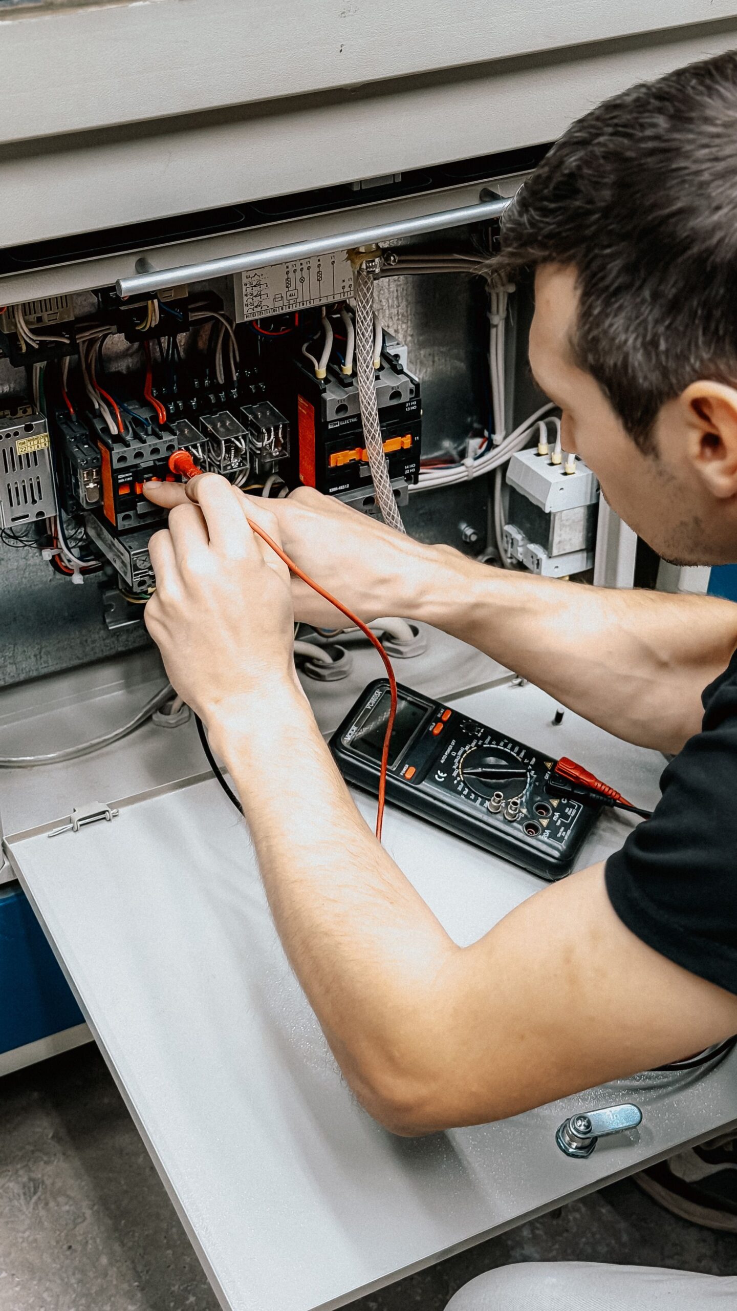 Electrician diagnosing an electrical panel during a service call